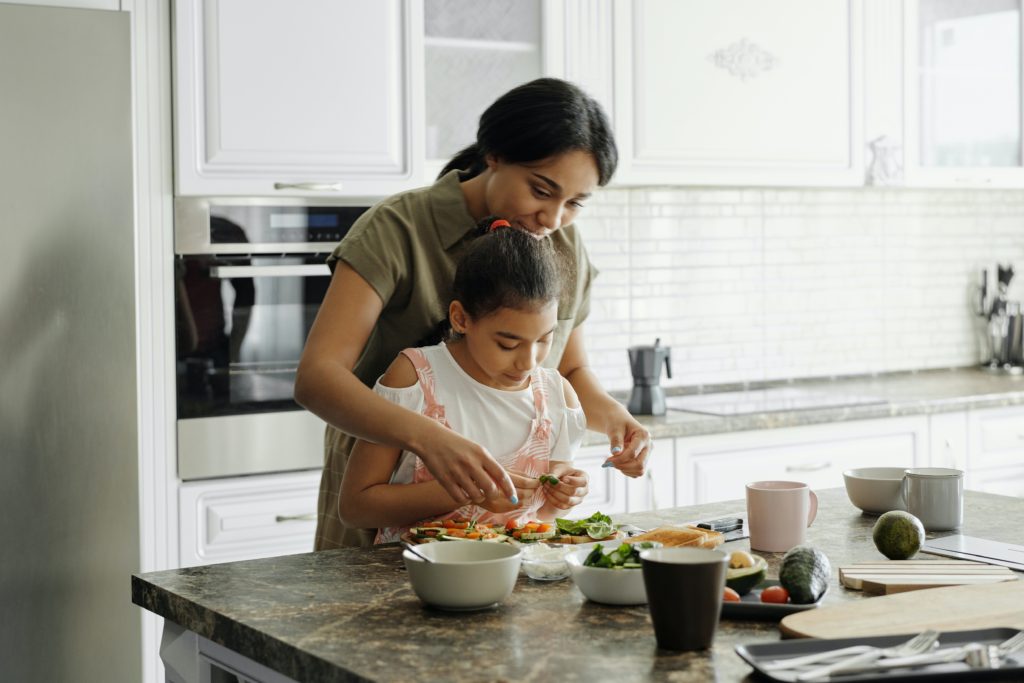 mother-and-daughter-preparing-avocado-toast-4259707